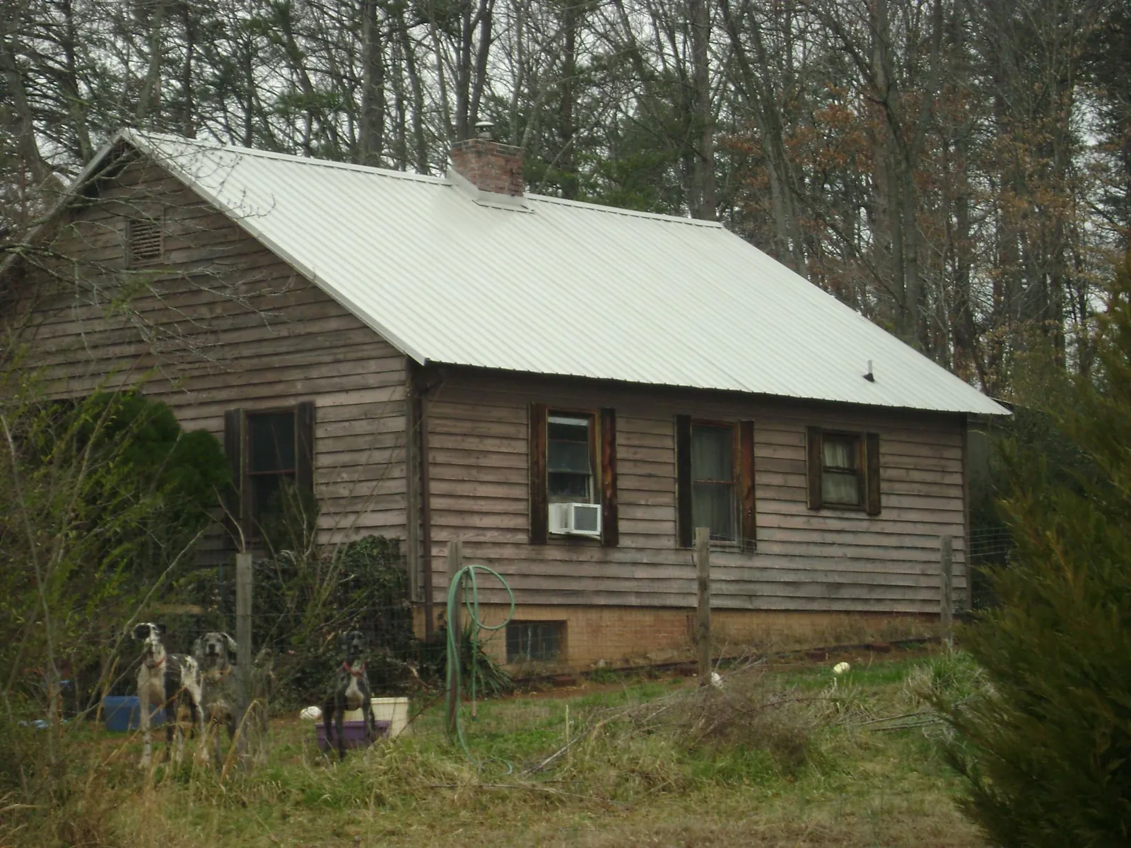 White metal roof on an old wood sided farmhouse, from a Metal Roof Installation job in Naples